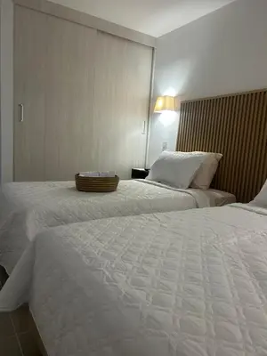 a hotel room with two beds and a lamp at Vicmag House Barranquilla in Barranquilla