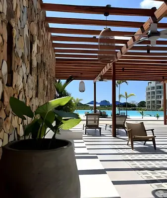a patio with benches and a stone wall at Baia Kristal: descanso, vista y naturaleza única in Los Arrayanes