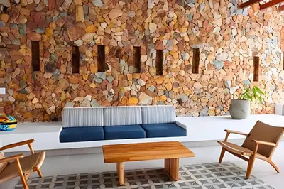 a living room with a couch and two chairs at Baia Kristal: descanso, vista y naturaleza única in Los Arrayanes