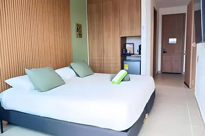 a bedroom with a bed with a phone on it at Baia Kristal: descanso, vista y naturaleza única in Los Arrayanes