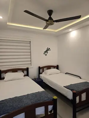 a bedroom with two beds and a ceiling fan at Apartamento Cerca al Mar Cartagena in Cartagena de Indias