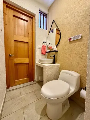 a bathroom with a toilet and a sink at Casa Stephanie - Getsemani - Private pool in Cartagena de Indias