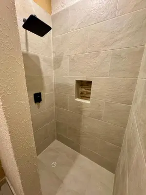 a shower with a large beige tiled shower at Casa Stephanie - Getsemani - Private pool in Cartagena de Indias