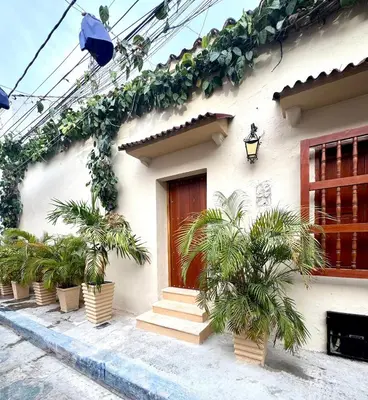 a house with potted plants on the side of it at Casa Stephanie - Getsemani - Private pool in Cartagena de Indias