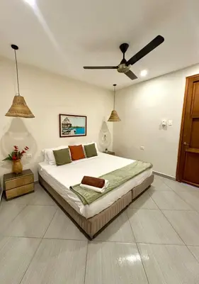 a bedroom with a bed and a ceiling fan at Casa Salvatore - Getsemani - Private pool in Cartagena de Indias