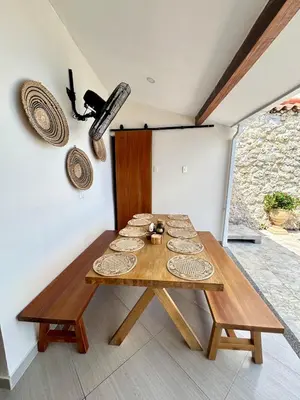 a dining room with a table with plates on it at Casa Salvatore - Getsemani - Private pool in Cartagena de Indias