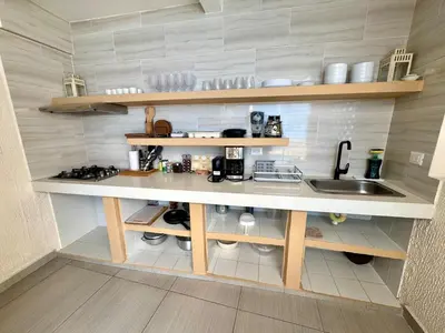 a small kitchen with a counter and a sink at Casa Salvatore - Getsemani - Private pool in Cartagena de Indias