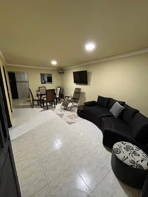a living room with a black couch and a table at Apartamento Barrio San Jose Barranquilla in Barranquilla