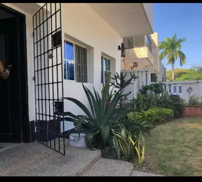 a house with a plant in front of a door at Alto prado 75 house in Barranquilla