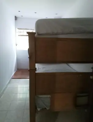a bunk bed in a room with a window at Alto prado 75 house in Barranquilla