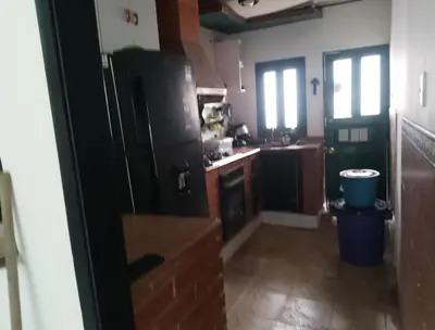 a kitchen with a black refrigerator and a sink at Alto prado 75 house in Barranquilla