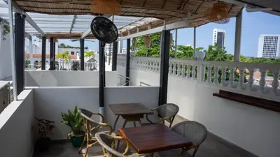 a balcony with two tables and chairs and windows at Art Hotel Getsemani in Cartagena de Indias