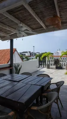 a wooden table and chairs on a patio at Art Hotel Getsemani in Cartagena de Indias