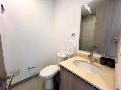 a bathroom with a sink and a toilet and a mirror at Apartamento familiar en Santa Marta con vista al mar y la Sierra in Santa Marta