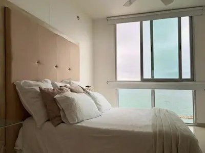 a bedroom with a large bed with a large window at Apartamento con vistas al Mar caribe in Coveñas