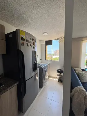 a kitchen with a stainless steel refrigerator in a room at Corazón de quilla in Barranquilla