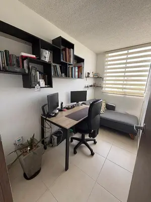 an office with a desk with two monitors and a couch at Corazón de quilla in Barranquilla
