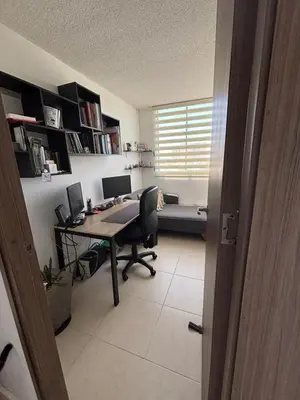 an office with a desk with a computer and a window at Corazón de quilla in Barranquilla