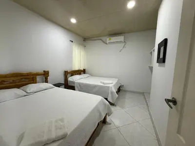 a small room with two beds and a window at Apartment 402 Tolú 2 habitaciones in Tolú