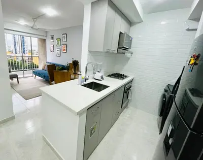 a white kitchen with a sink and a stove at Beach Nearby Stunning Views Ultimate Comfort in Cartagena de Indias