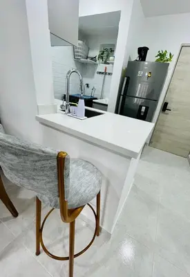 a kitchen with a white counter and a chair at Beach Nearby Stunning Views Ultimate Comfort in Cartagena de Indias
