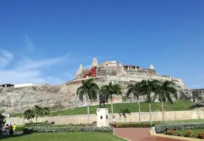 a castle on top of a mountain with palm trees at Beach Nearby Stunning Views Ultimate Comfort in Cartagena de Indias