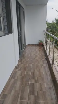 a room with a wooden floor and a balcony at MiraMar in Guayabal