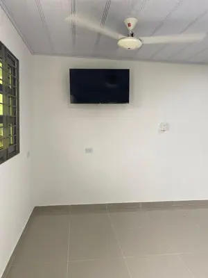 a room with a tv on a white wall at MiraMar in Guayabal