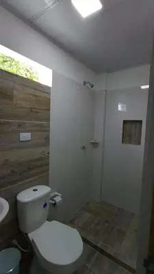 a bathroom with a white toilet and a sink at MiraMar in Guayabal