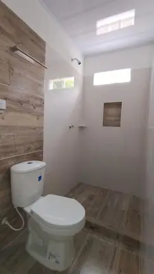 a bathroom with a white toilet and wooden floors at MiraMar in Guayabal