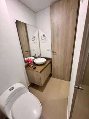 a bathroom with a toilet and a sink and a mirror at Ocean Drive Cartagena Apto con Piscina Infinity in Cartagena de Indias