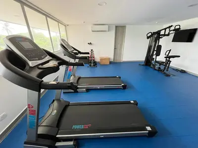 a gym with three treadmills and a treadmill at Ocean Drive Cartagena Apto con Piscina Infinity in Cartagena de Indias
