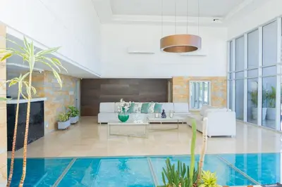 a living room with a couch and a pool at Ocean Drive Cartagena Apto con Piscina Infinity in Cartagena de Indias