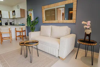 a living room with a white couch and two tables at Baia Kristal Top Floor-Elegance and Luxury View in Los Arrayanes