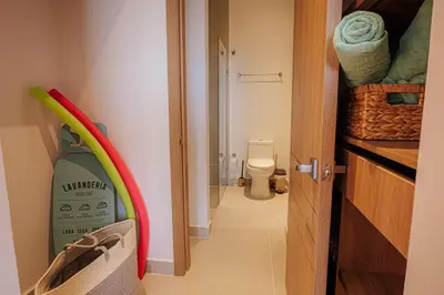 a bathroom with a door open to a bathroom with a toilet at Baia Kristal Top Floor-Elegance and Luxury View in Los Arrayanes