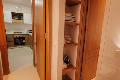 a small kitchen with a door open to a pantry at Baia Kristal Top Floor-Elegance and Luxury View in Los Arrayanes