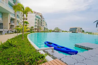 a large swimming pool with a blue boat in it at Baia Kristal Top Floor-Elegance and Luxury View in Los Arrayanes