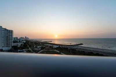 a view of the beach at sunset from a building at Maravillosa suite frente al mar y atardecer CB911 in Cartagena de Indias