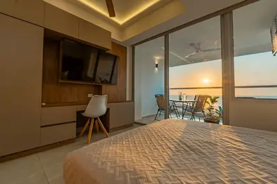 a bedroom with a bed and a tv and a table at Maravillosa suite frente al mar y atardecer CB911 in Cartagena de Indias