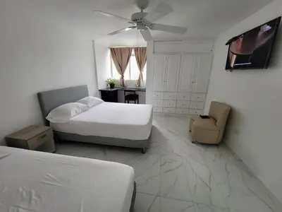 a bedroom with two beds and a ceiling fan at Large and beautiful Oceanfront Penthouse in Cartagena de Indias