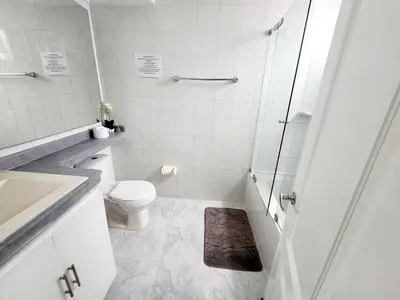 a white bathroom with a toilet and a shower at Large and beautiful Oceanfront Penthouse in Cartagena de Indias
