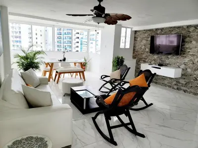 a living room with a couch and chairs and a tv at Large and beautiful Oceanfront Penthouse in Cartagena de Indias