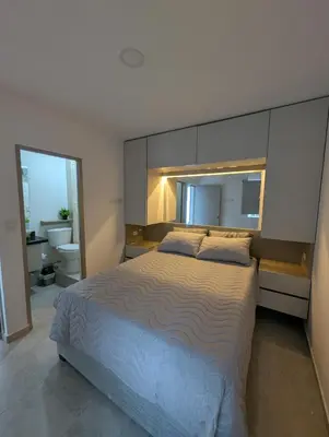 a bedroom with a large bed and a bathroom at Apartamento amoblado en Cartagena cerca a la playa in Cartagena de Indias