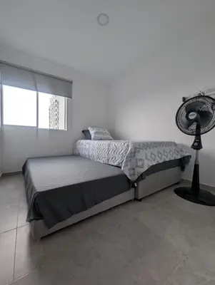 a bedroom with a bed and a fan at Apartamento amoblado en Cartagena cerca a la playa in Cartagena de Indias