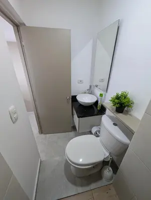 a white bathroom with a toilet and a sink at Apartamento amoblado en Cartagena cerca a la playa in Cartagena de Indias