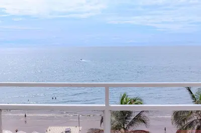 a view of the ocean from a balcony at Spacious beachfront apartment in Cartagena de Indias