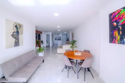 a living room with a table and a couch at Spacious beachfront apartment in Cartagena de Indias