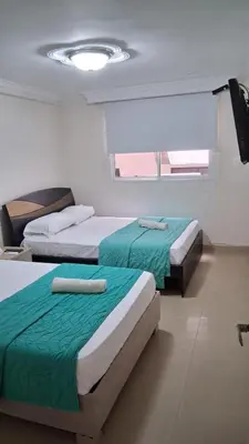a bedroom with two beds and a window at apartamento en marbella dúplex, cerca centro histórico - 3 in Cartagena de Indias