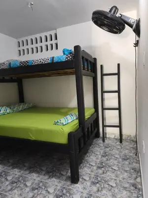 a room with two bunk beds and a lamp at Las Margaritas Frente al Mar 1 in Coveñas
