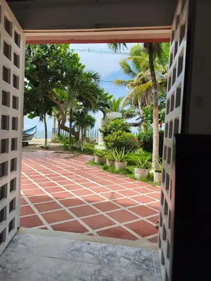 an open door to a patio with a view of the ocean at Las Margaritas Frente al Mar 1 in Coveñas